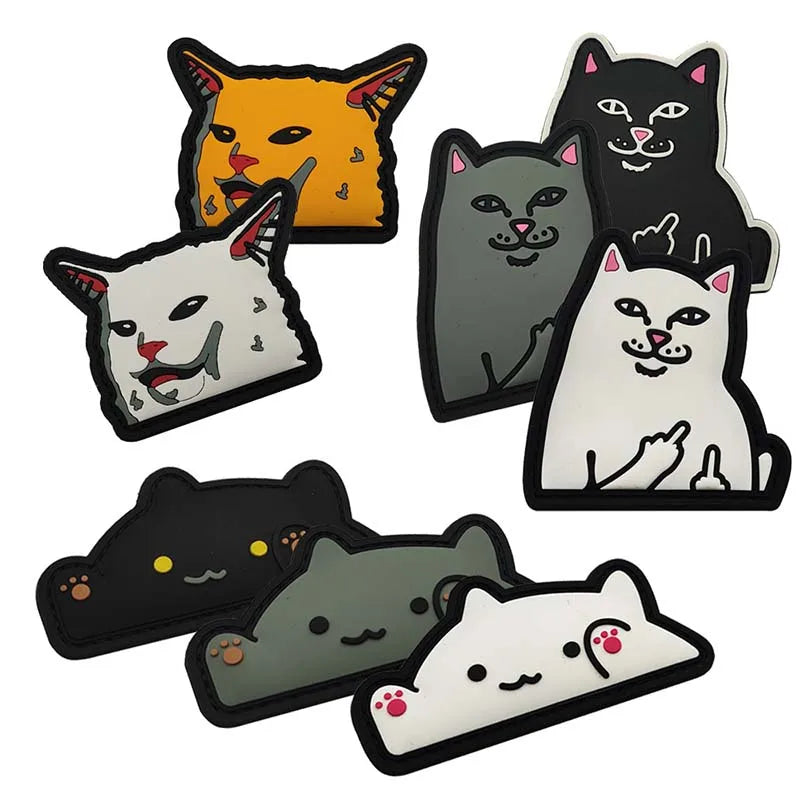 A collection of embroidered patches featuring various animal faces and meme expressions in orange, gray, black, and white.