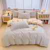 A beige and white striped cotton duvet cover and pillow set displayed on a bed with natural light.