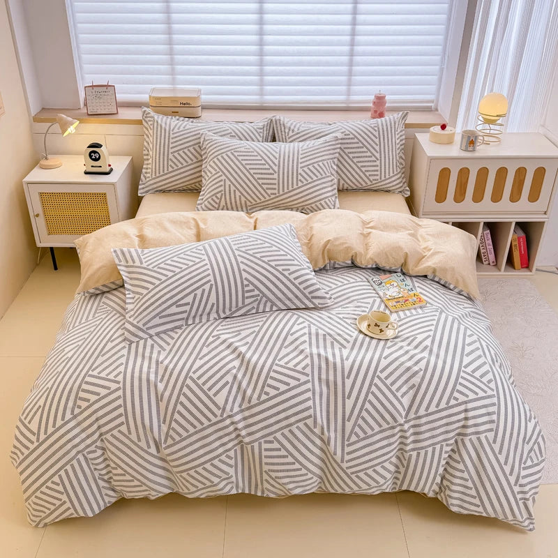A beige and white striped cotton duvet cover and pillow set displayed on a bed with natural light.