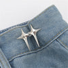 Silver star-shaped adjustable button clips attached to a denim fabric