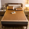 A natural bamboo cooling mat is displayed on a wooden bed frame with bedding and side tables.