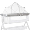 A portable bassinet with a clear mosquito net cover for baby sleep.