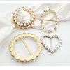 Gold and silver metal ring clips featuring pearl and heart designs for clothing and accessories