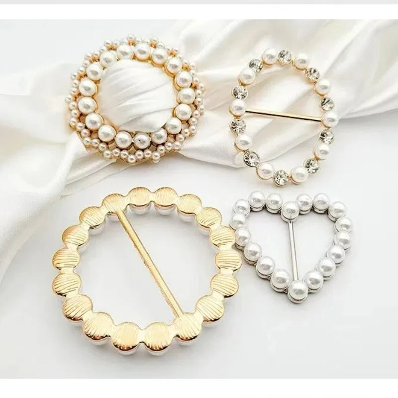 Gold and silver metal ring clips featuring pearl and heart designs for clothing and accessories