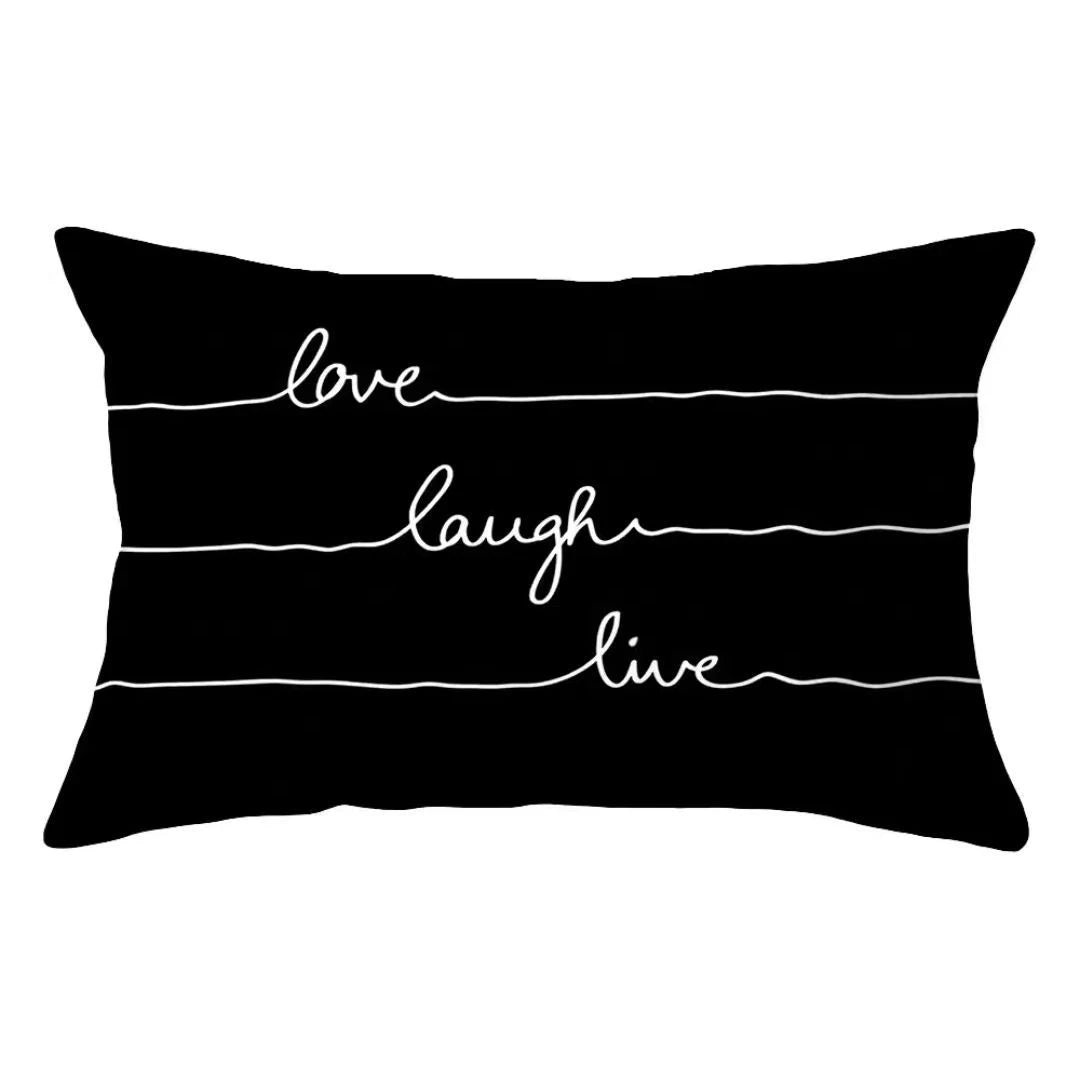 A black pillow cover with three horizontal white lines and the words love laugh live written on it.