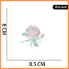 Five gold embroidered rose patches shown against a measurement scale.