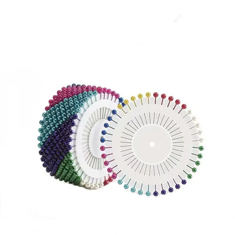 Colorful pearl straight head pins arranged in a fan pattern for crafting