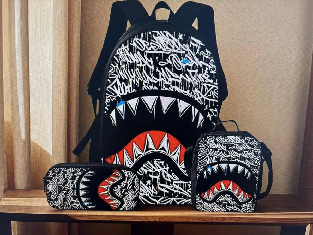 A black backpack and matching pouch featuring a white graphic print of a fierce dog's mouth.