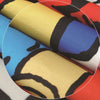 Rolls of versatile muscle and creativity apron fabric in various colors including yellow, blue, red, and white.