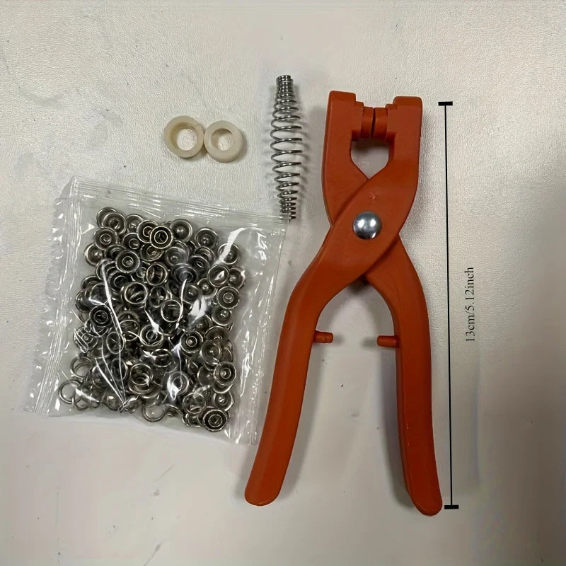 An orange precision snap button kit includes a pair of pliers and numerous small metal snap buttons.