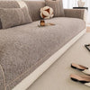 A textured gray sofa cushion cover with a white trim, featuring decorative pillows and a small candle.
