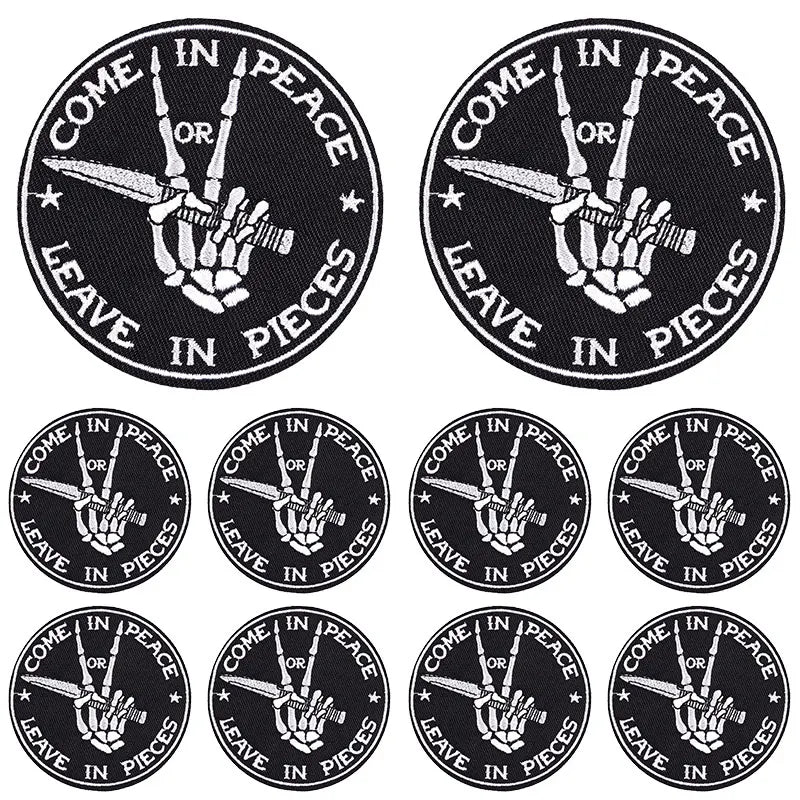 A set of black embroidery patches featuring the phrase Come in Peace or Leave in Pieces with a hand gesture.