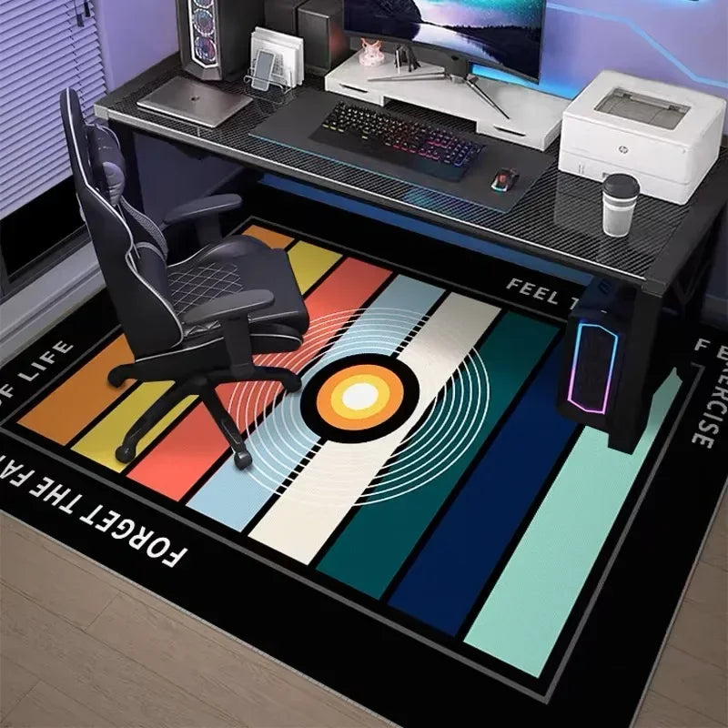A black gaming desk setup featuring a neon hexagon area rug with colorful stripes and a computer monitor.
