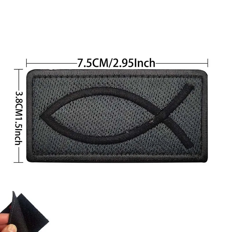 Black embroidered patch featuring a cross and flag design, measuring 7.5cm wide.