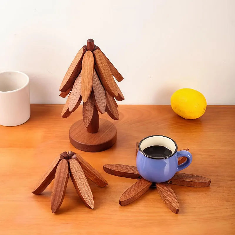 A wooden decorative item shaped like a pinecone or stylized leaf arrangement sits next to a yellow lemon and a blue ceramic m