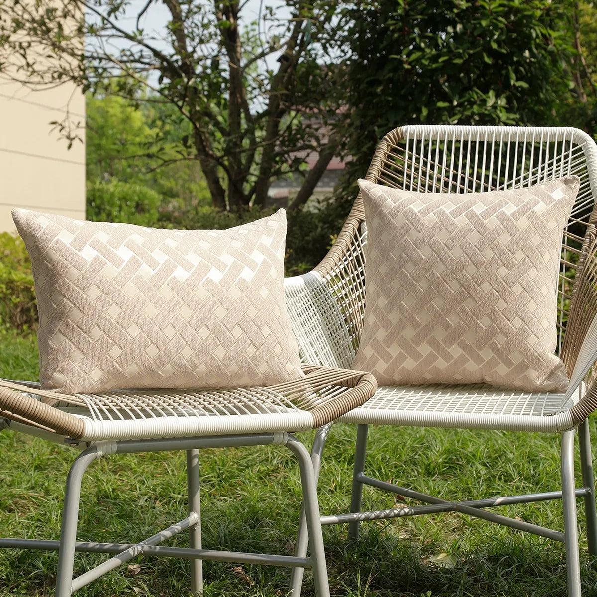 A beige chenille jacquard throw pillowcase with a diamond pattern resting on a woven outdoor chair.