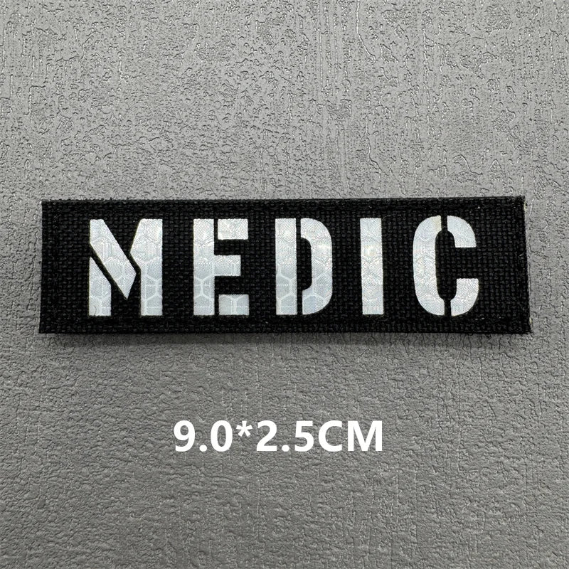 Black embroidered patch with the word MEDIC in white text