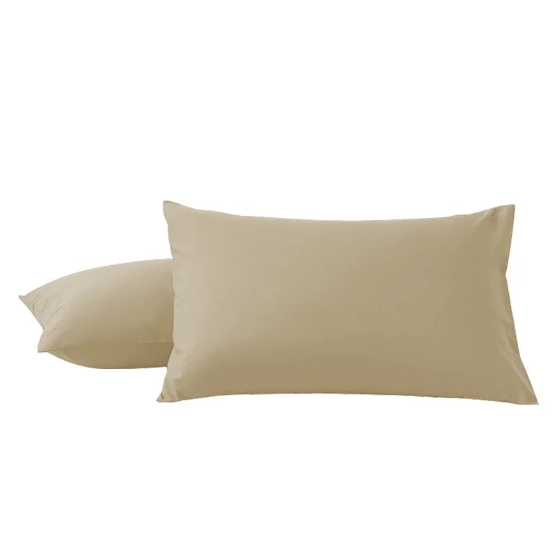 Two beige microfiber pillow covers lying side by side.