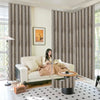 Elegant gray and gold patterned blackout curtains framing a living room with a sofa and accent table.