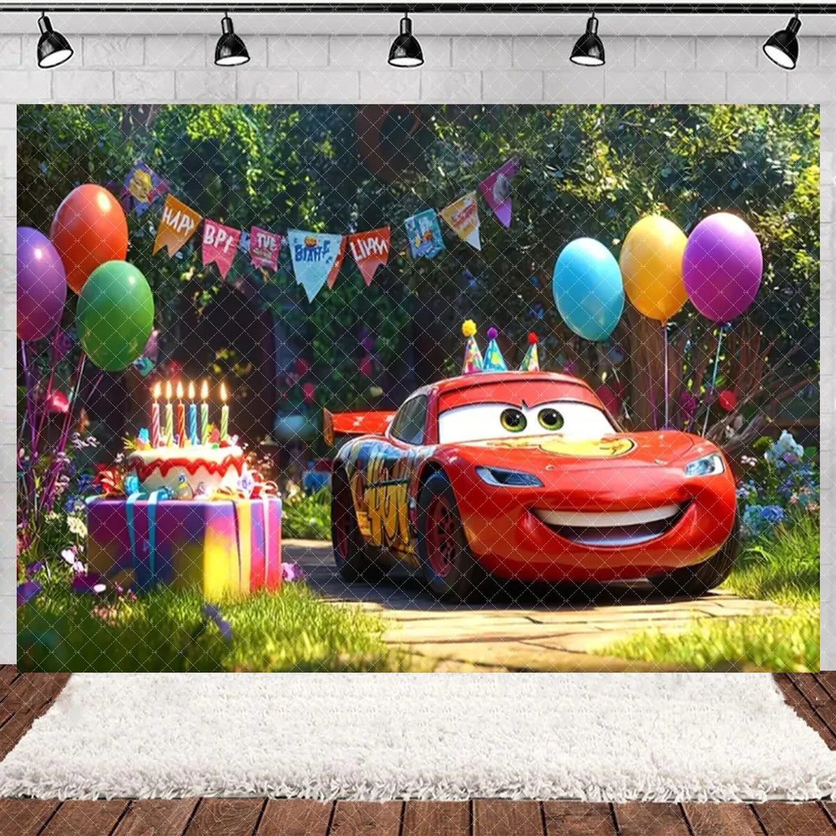 A cartoon racing car is featured in a birthday party backdrop with colorful balloons and greenery.