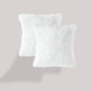A white, fluffy velvet throw pillow cover is shown against a light gray background.
