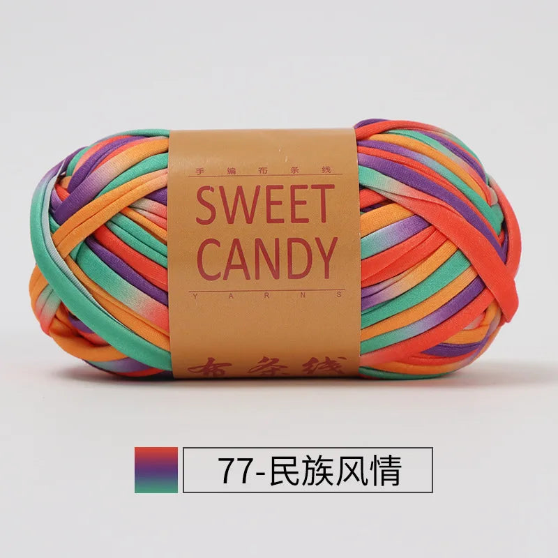 A ball of hand-dyed, multicolored striped yarn for crochet and knitting, packaged with a brown label.