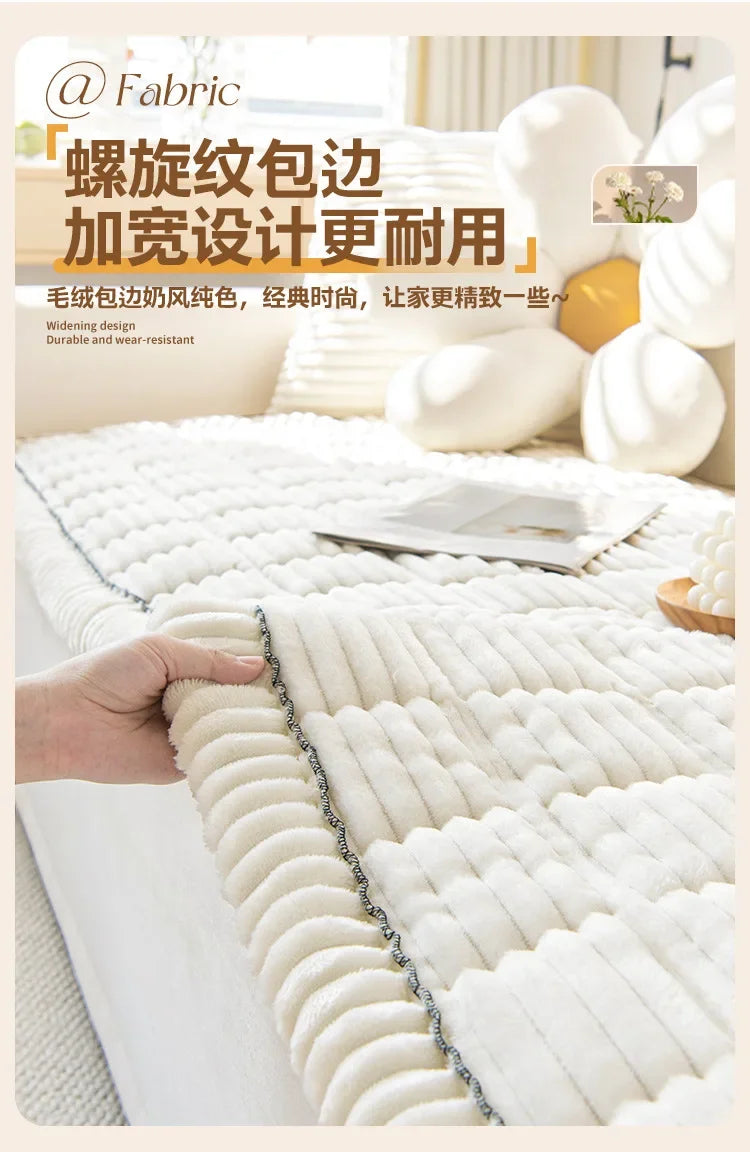 A close-up of a white, textured corduroy sofa armrest cover being held by a hand.