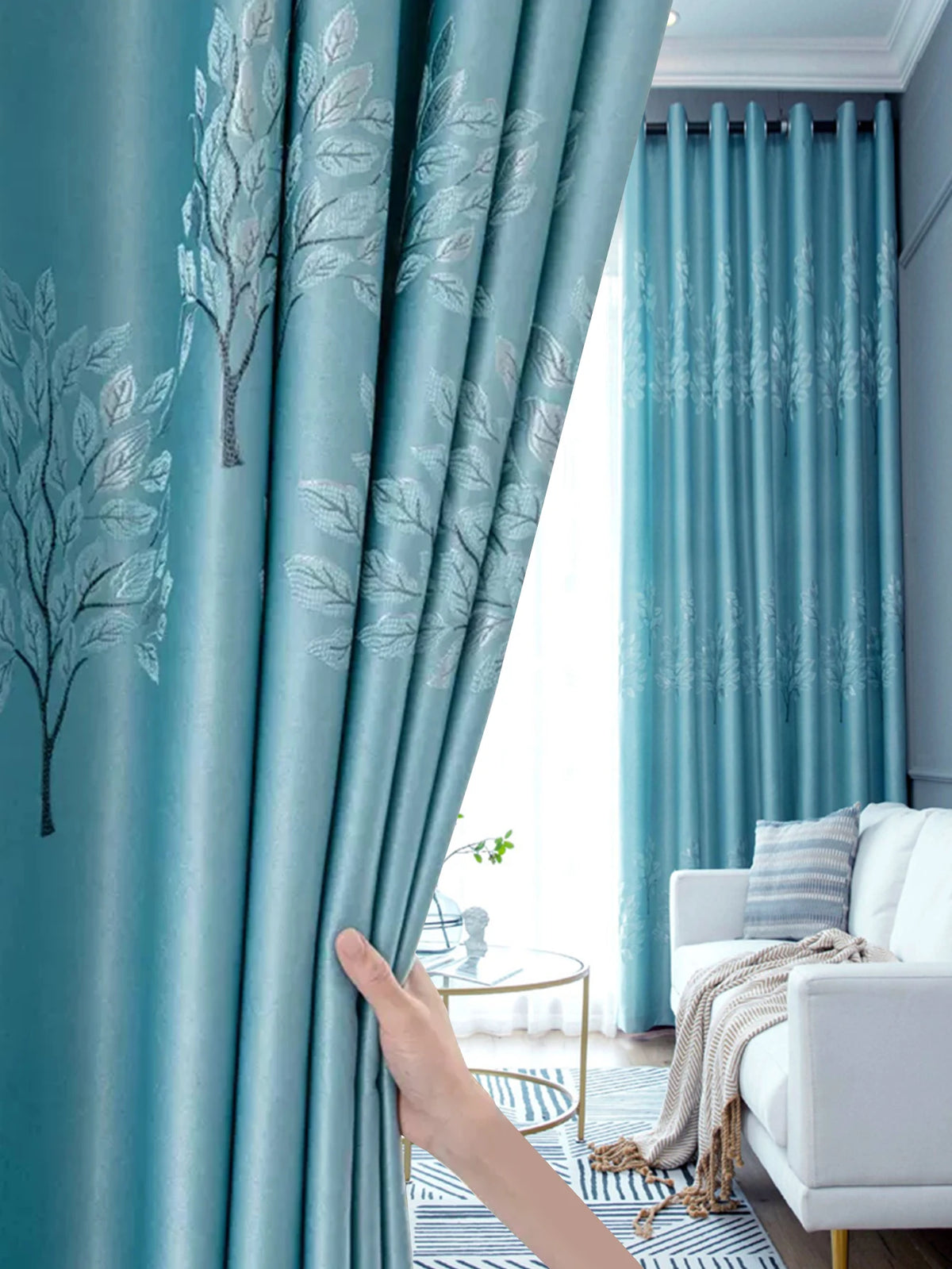 Light blue sheer curtains with a white tree pattern framing a bright window.