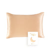A rectangular, satin-finish pillow in a nude beige color.