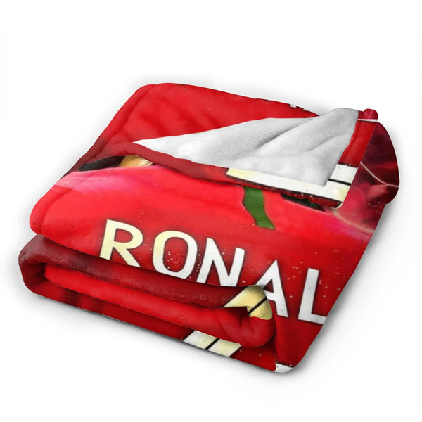 A red wool throw blanket featuring a football theme with the word RONAL visible.