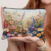 A hand holds a floral canvas cosmetic bag with a zipper closure featuring detailed pressed flowers and greenery.