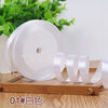 Roll of white satin ribbon for crafting or decoration
