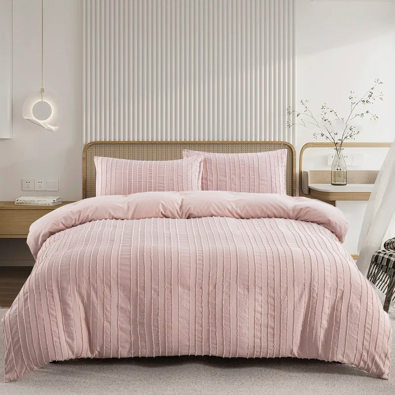 A pink boho tufted microfiber duvet cover set displayed on a bed with a light wood frame and white vertical paneling.