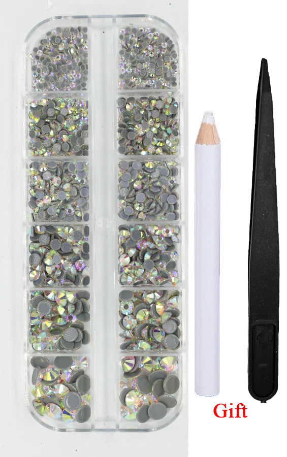 A clear plastic container holds various sizes of crystal hot fix rhinestones and an applicator tool.