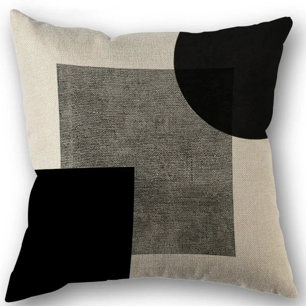 Abstract geometric pillow cover featuring a patchwork of black, gray, and beige squares.