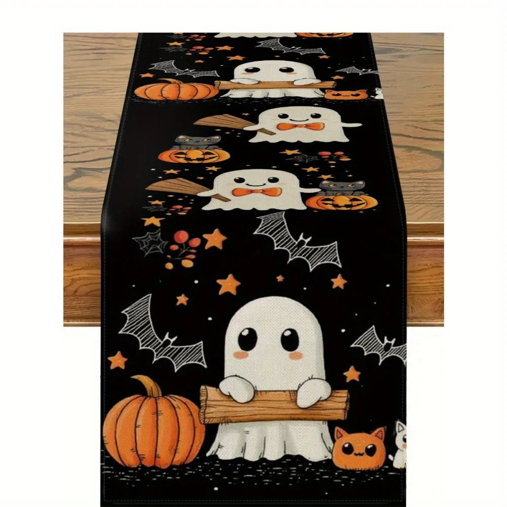 Black Halloween table runner featuring a pattern of white ghosts, pumpkins, bats, and cats.