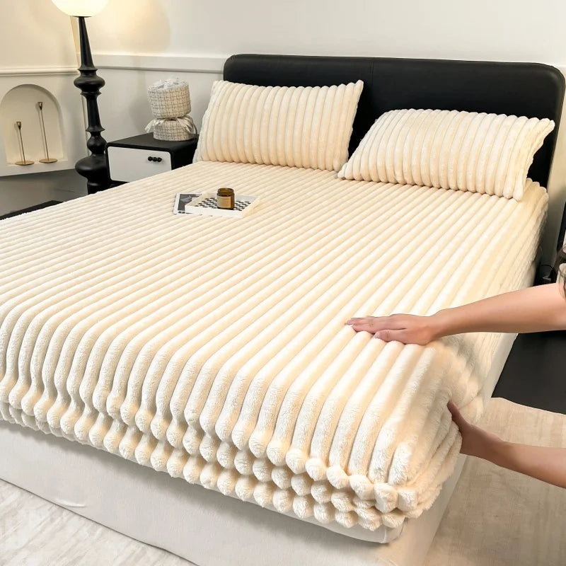 A close-up of thick, cream-colored winter fitted bed sheets with vertical ribbing on a bed.