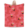 A red flannel throw blanket featuring cartoon characters Elmo and Friends