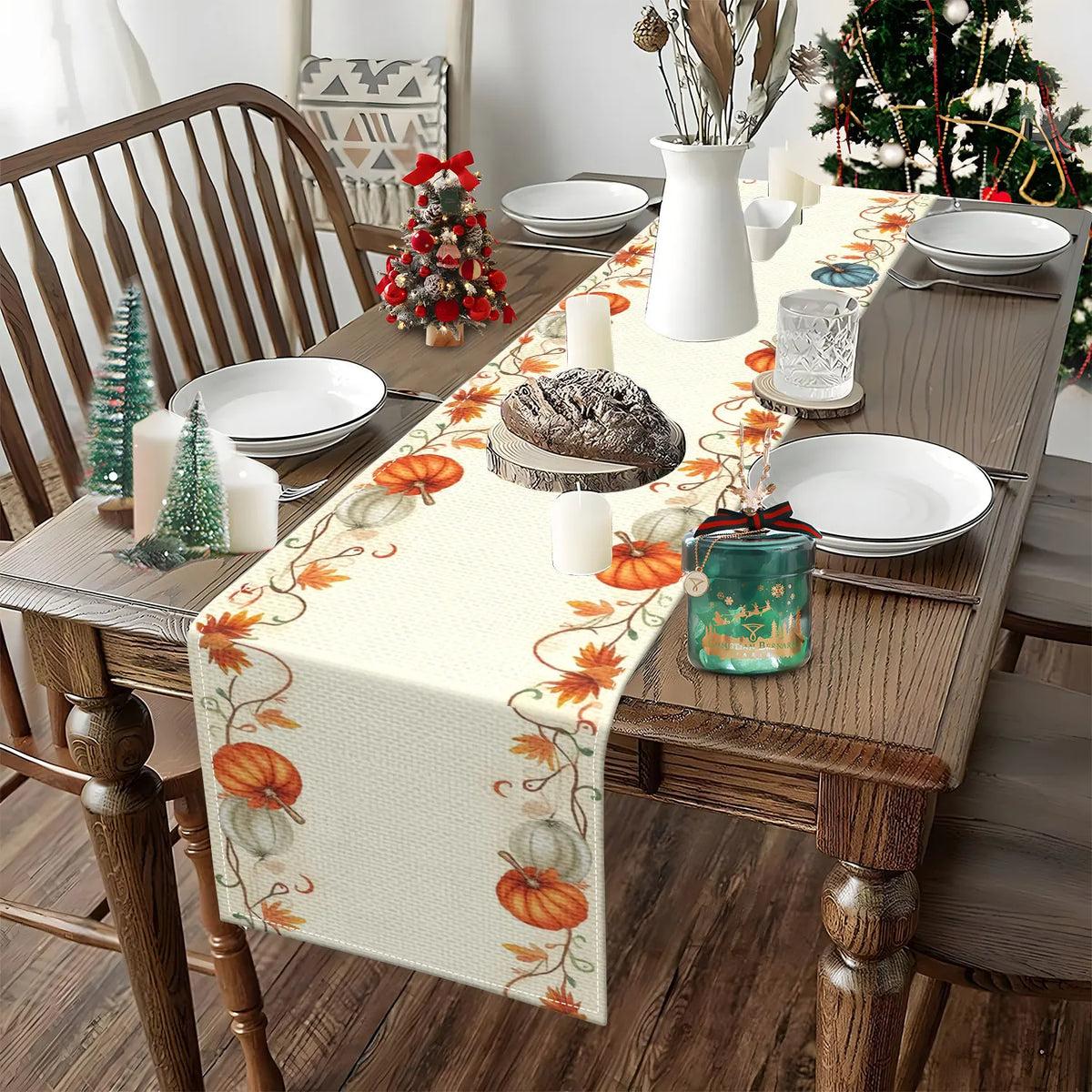 An autumn harvest table runner with orange and green floral patterns on a wooden dining table set for a meal.