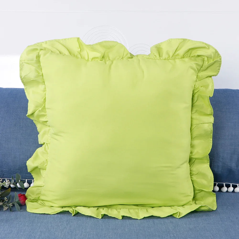 A bright lime green ruffled pillow cover displayed on a blue fabric background.