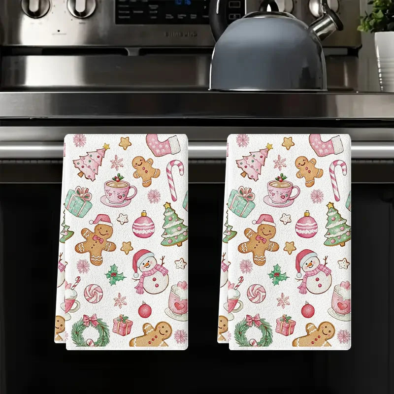 A set of two festive pink snowman Christmas kitchen towels featuring seasonal designs and patterns.