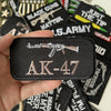 A black iron-on patch featuring the AK-47 silhouette and text on a hand.