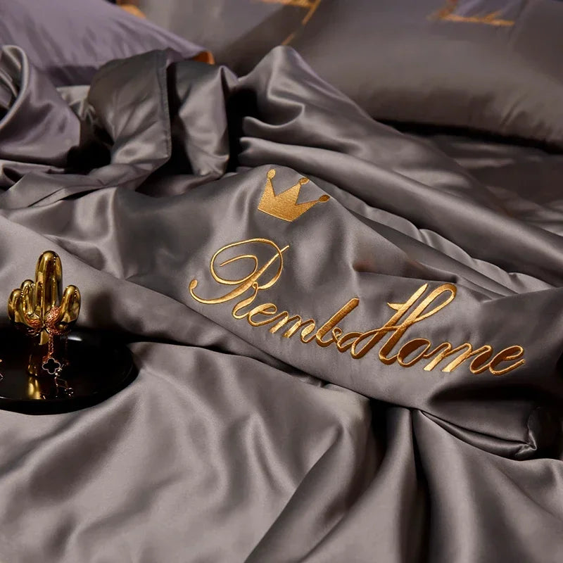 A luxurious gray ice silk blanket set with gold embroidery spelling out RememberHome