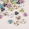 A collection of flower-shaped resin button rhinestones in various colors including pink, green, purple, and white.
