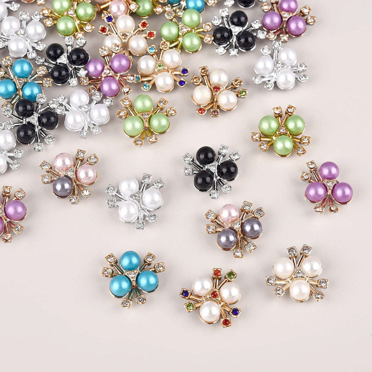 A collection of flower-shaped resin button rhinestones in various colors including pink, green, purple, and white.