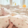 A light pink duvet set featuring a cute dog print, displayed on a bed with pillows and natural light.