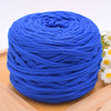 A ball of bright blue polyester craft yarn for knitting and DIY displayed on a wooden surface.