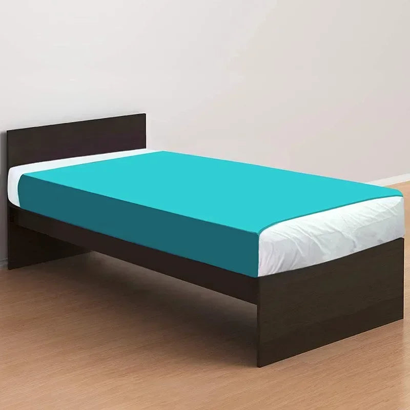 A dark brown bed frame with a teal fitted sheet and white bedding on a wooden floor.