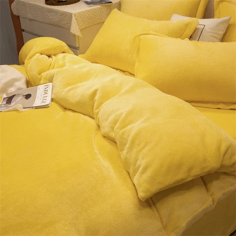 A bright yellow luxurious flannel duvet cover set with fluffy pillows on a bed.