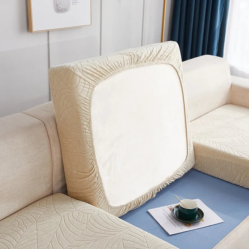 A beige waterproof jacquard stretch sofa cover displayed on a light-colored sofa.
